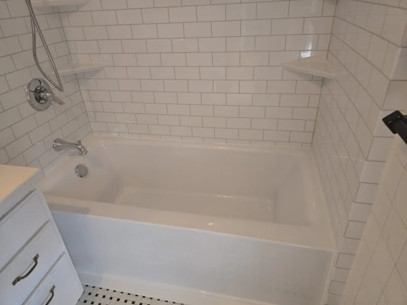 New white subway-tile tub and shower installed by Yankee Home