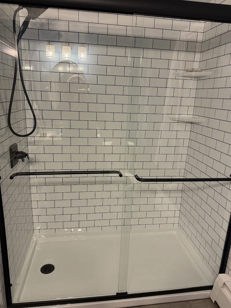 New white subway-tile walk-in shower installed by Yankee Home