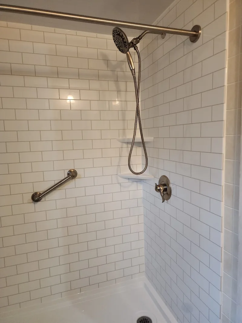 New walk-in shower with grab bar installed by Yankee Home